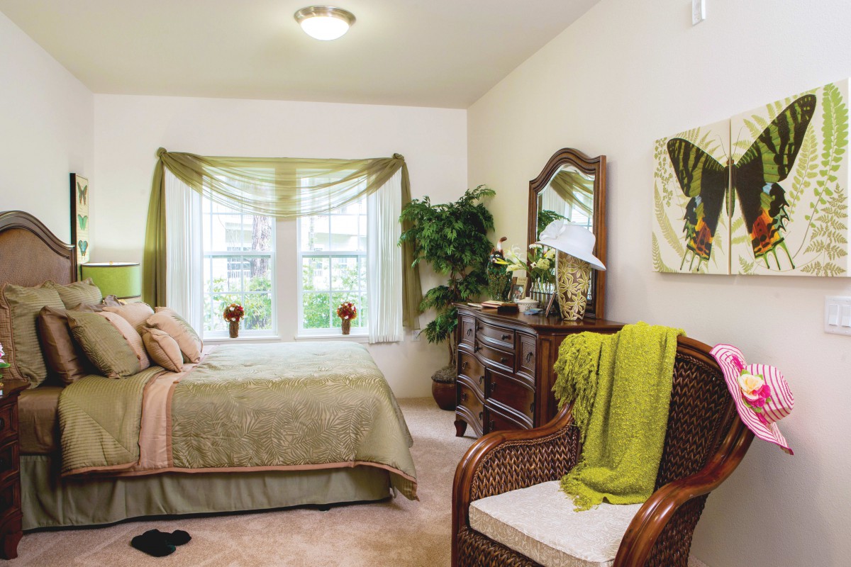 Cozy bedroom with elegant decor and natural light.