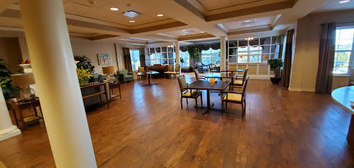 A cozy lounge area with comfortable seating and ample natural light, perfect for relaxation or socializing.