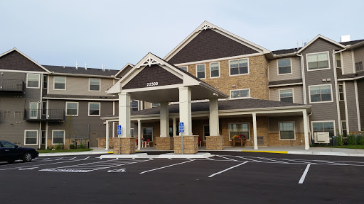 Front view of a hotel with a welcoming entrance and parking area.