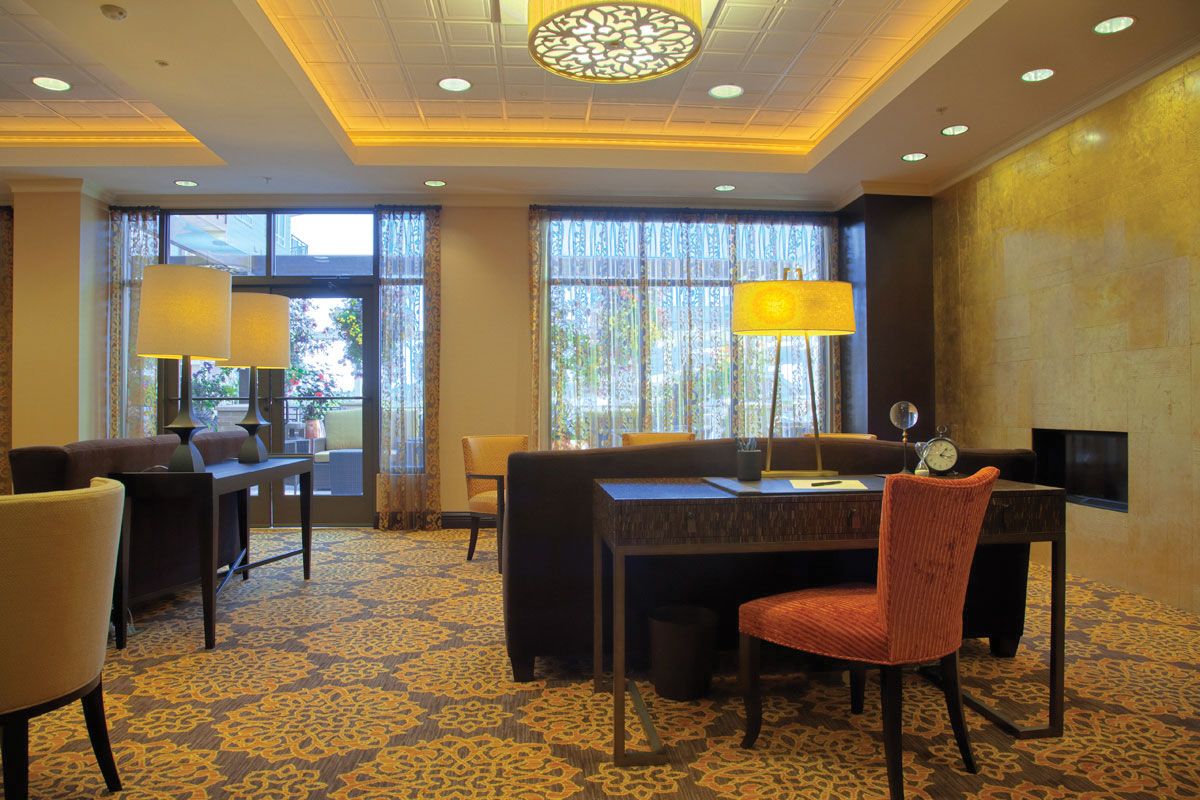A cozy hotel lobby with elegant lighting and comfortable seating arrangements.