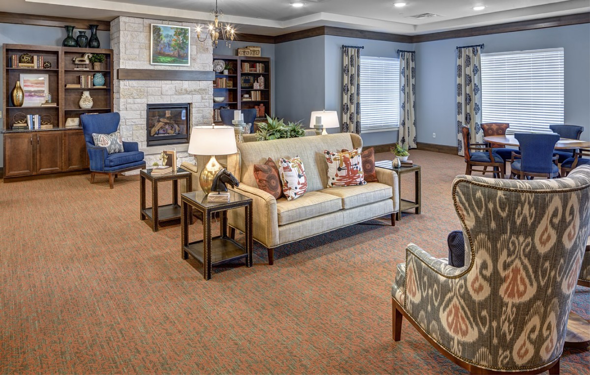 A cozy living room with comfortable furniture and a warm fireplace.