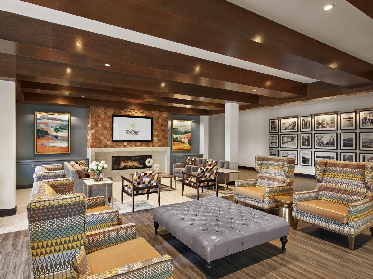 A modern lounge with comfortable seating and a cozy fireplace.