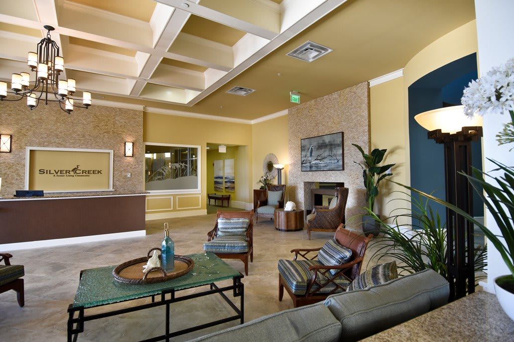 A modern lobby area with comfortable seating, stylish decor, and ambient lighting.