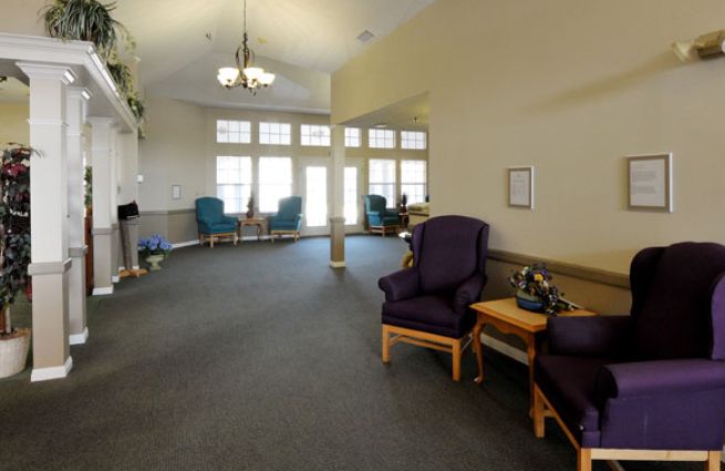 A spacious lobby area with comfortable seating and large windows allowing natural light.