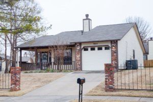 A suburban house with a brick exterior and a single garage.