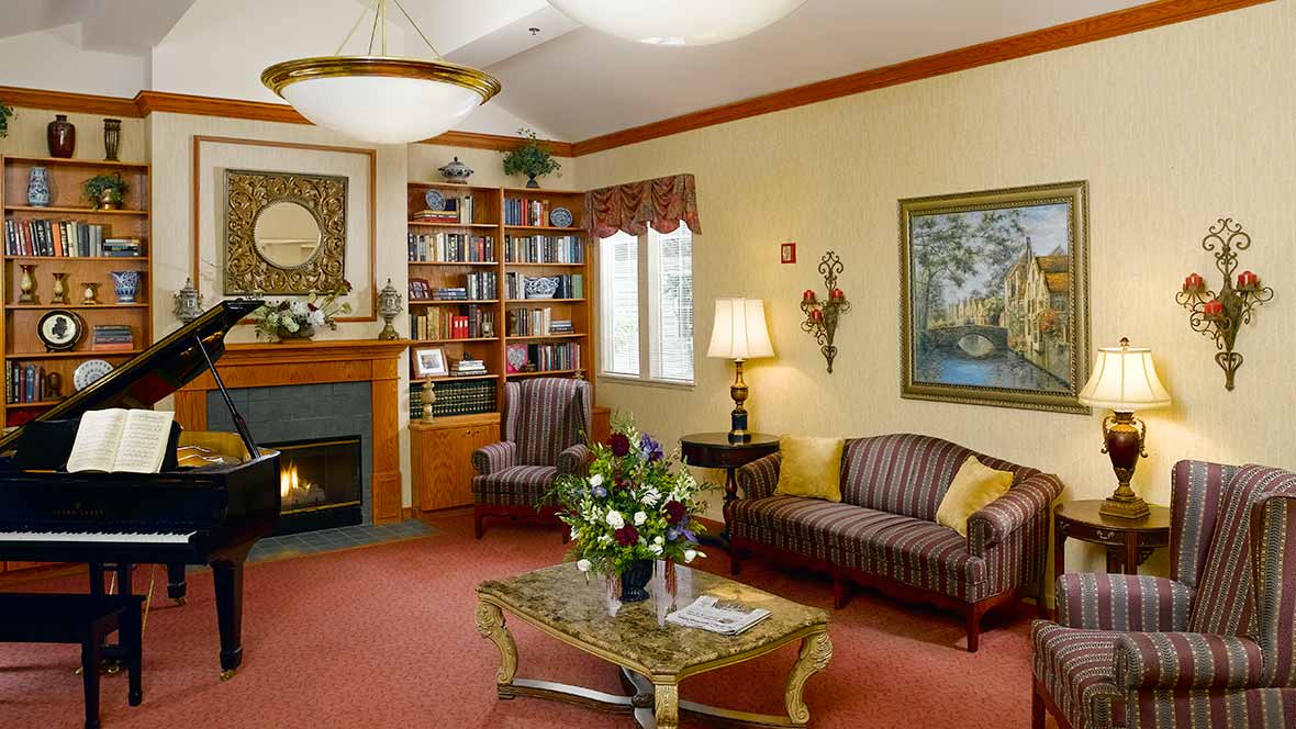 A cozy living room with elegant furniture, a fireplace, and decorative elements.