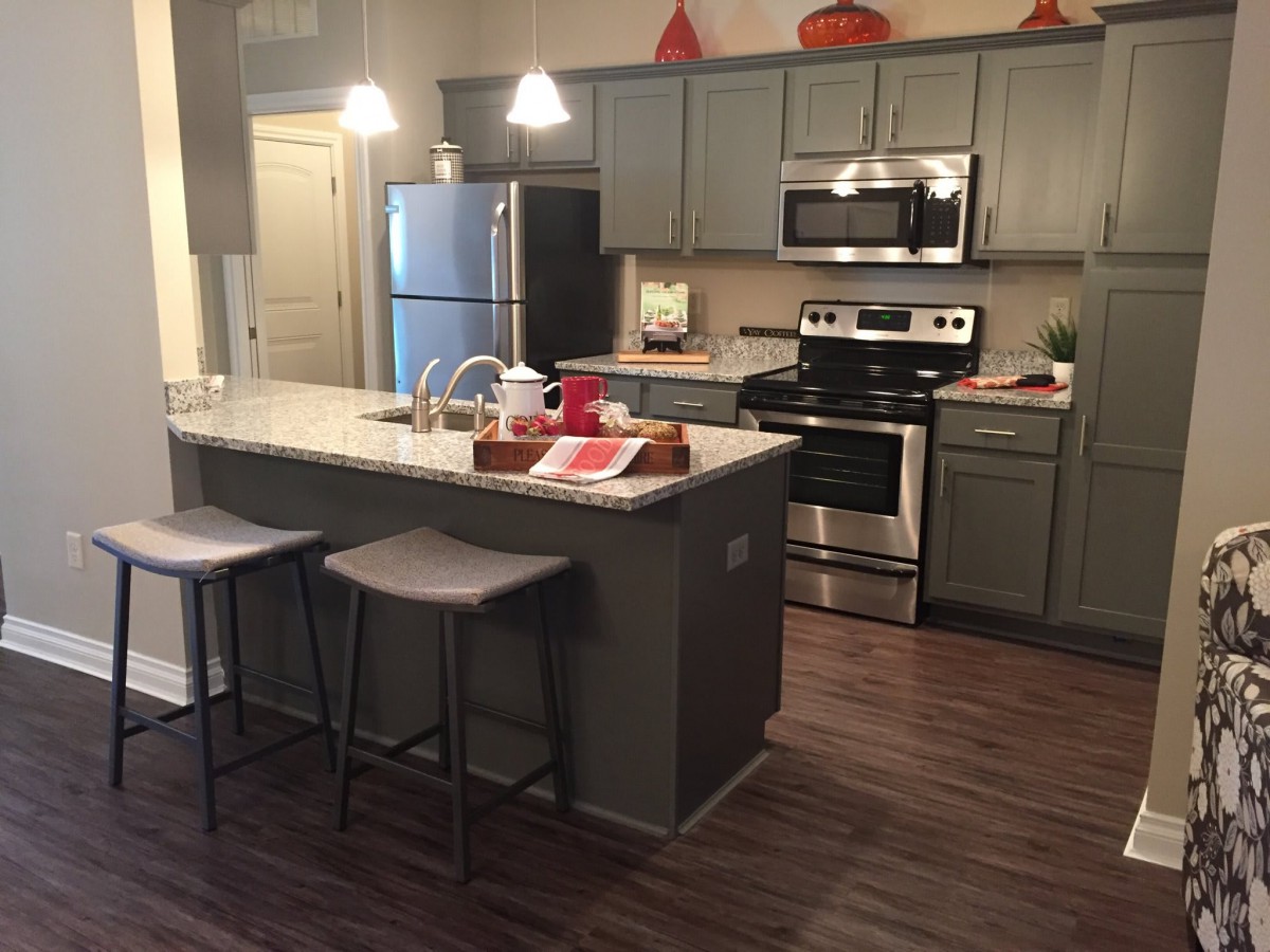Modern kitchen with island and stainless steel appliances.