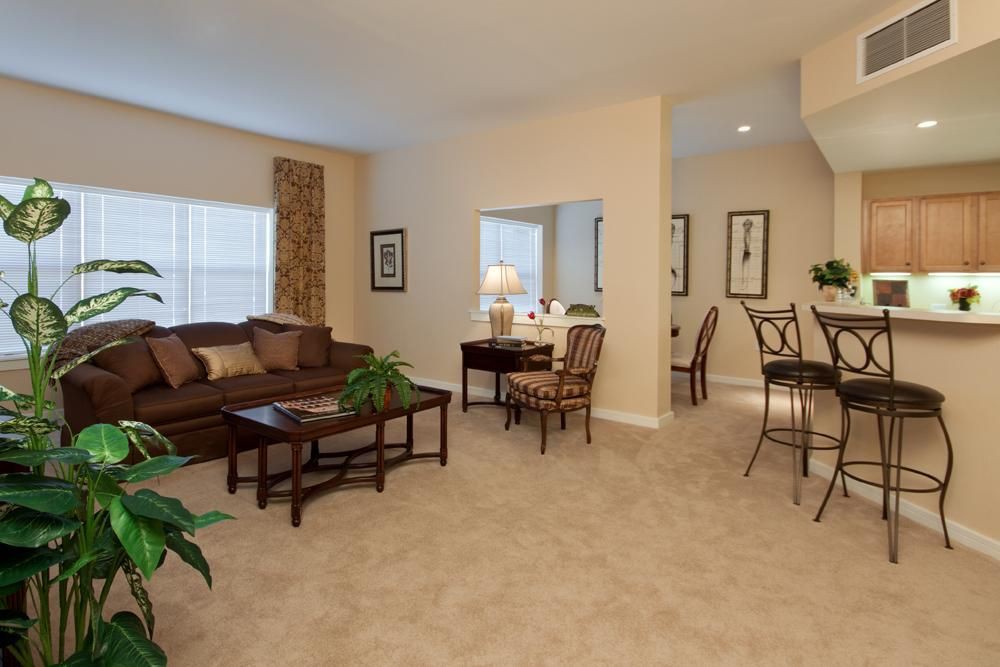 A spacious living room with a comfortable seating area and adjacent dining space.