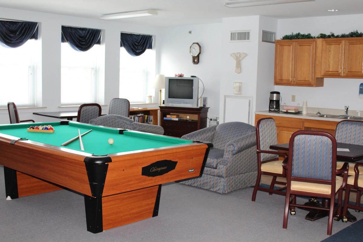 A cozy game room featuring a pool table and a television for entertainment.