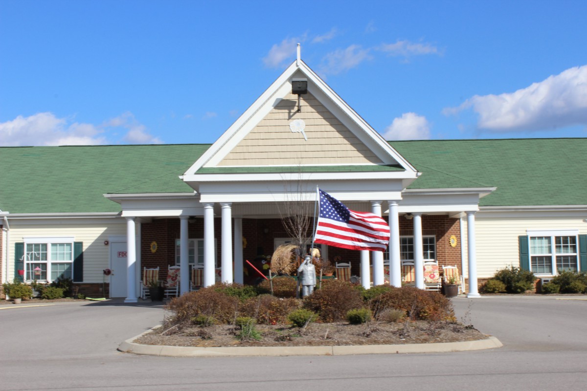 A building with an American flag at the entrance on a clear day.
