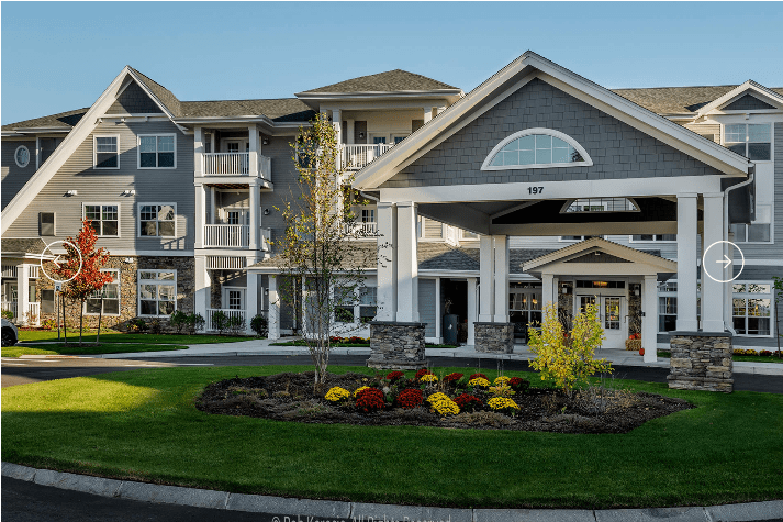 A modern residential building with a landscaped entrance.