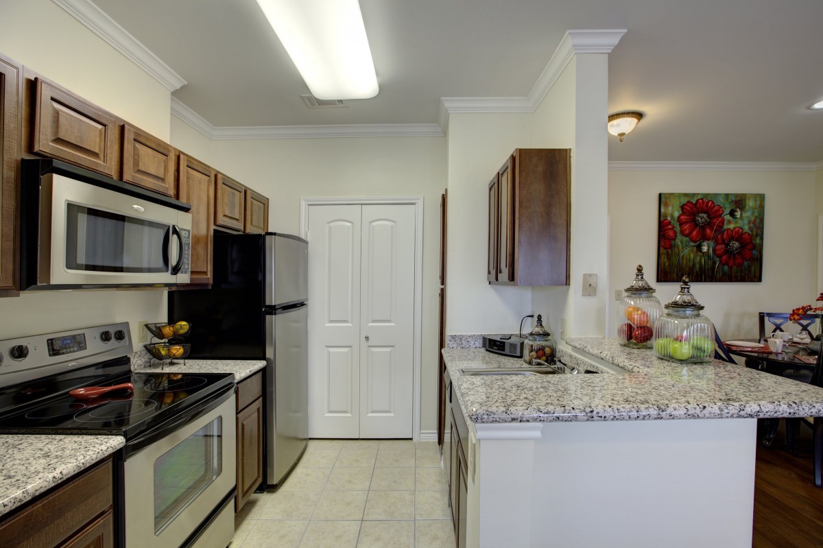 A modern kitchen with stainless steel appliances and granite countertops.