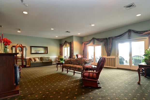 A spacious living room with elegant furniture and large windows.