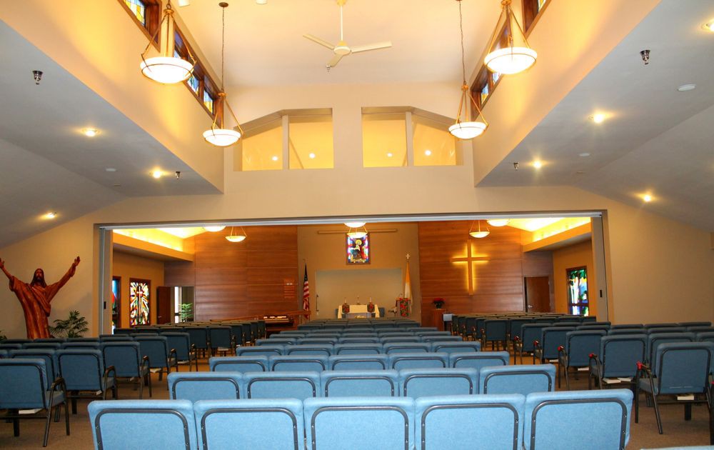 Interior view of a church with rows of seats facing the altar.