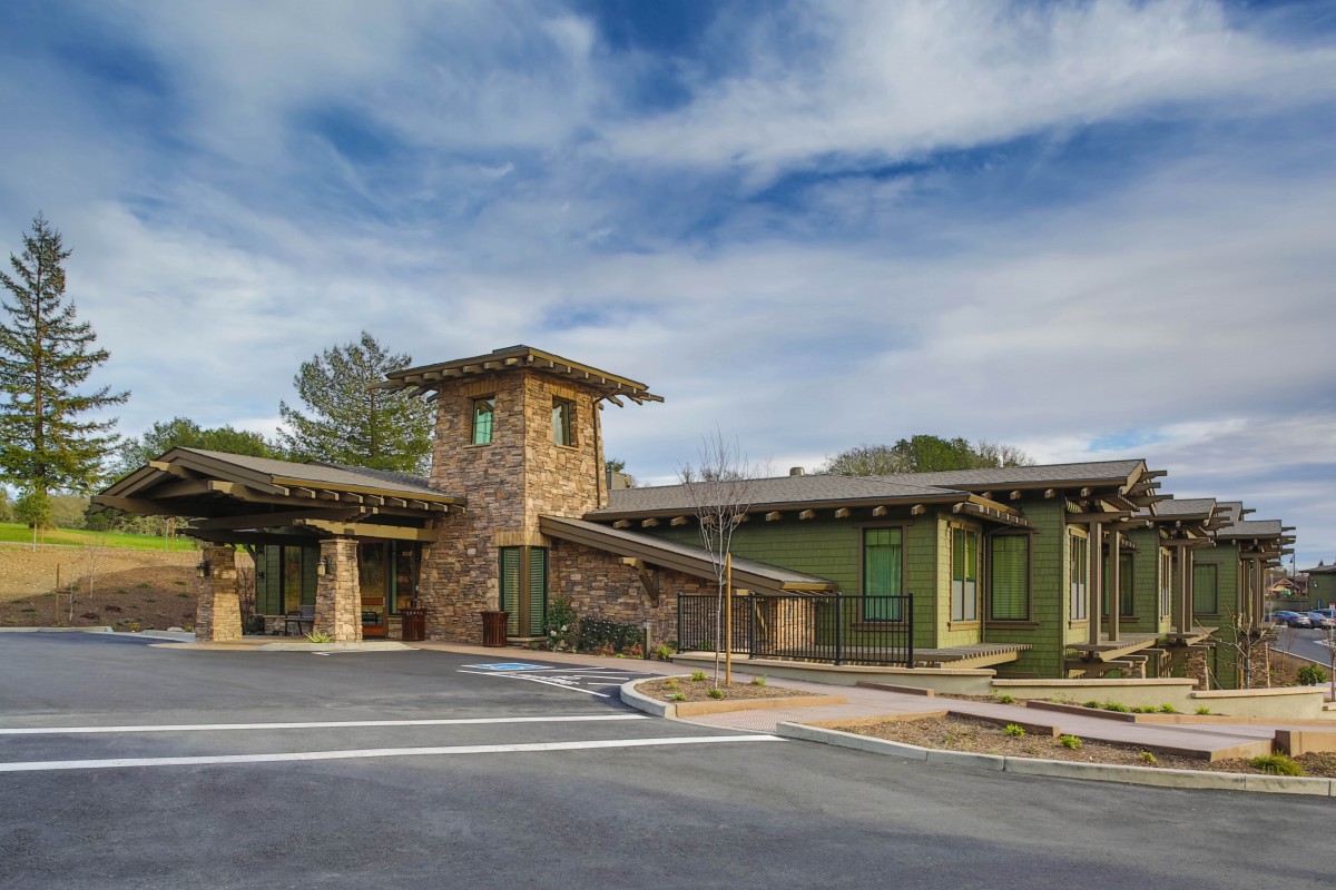 A modern building featuring stone architecture under a blue sky.