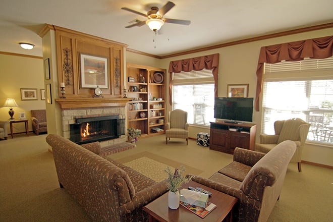 A cozy living room with a fireplace, television, and ample seating.