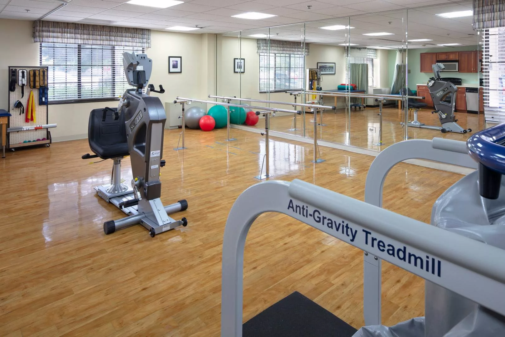 A gym equipped with an anti-gravity treadmill and various exercise machines, ideal for rehabilitation and therapy.
