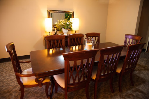 A cozy and elegant dining room setup featuring a wooden table and chairs, complemented by soft lighting and decorative elements.
