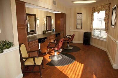 An interior view of a salon with chairs and mirrors for hair styling.