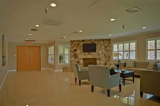 A modern and inviting lobby area featuring comfortable seating and a cozy fireplace.