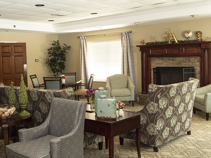 A cozy living room with comfortable seating and a fireplace.