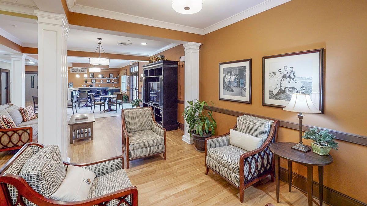 Cozy lounge area with seating and decor in a warm-toned room.