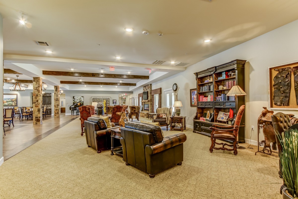 A cozy library with comfortable seating and well-lit bookshelves.