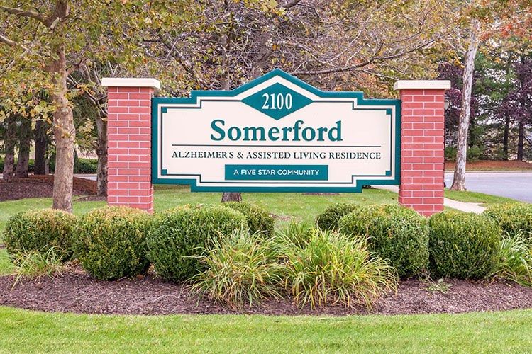 Somerford Alzheimer's and Assisted Living Residence sign with brick pillars and landscaping.