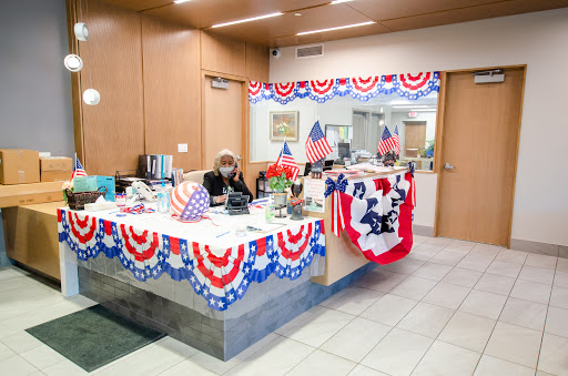 A festive office space decorated with patriotic themes, featuring flags and red, white, and blue elements.