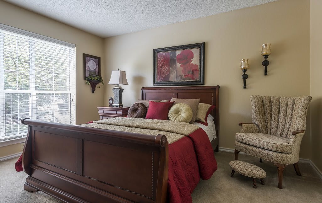 A cozy bedroom with a wooden bed and warm decor.