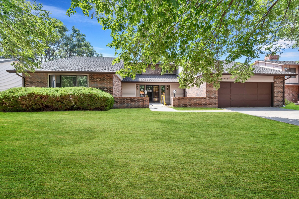 A suburban house with a well-maintained front yard and driveway.