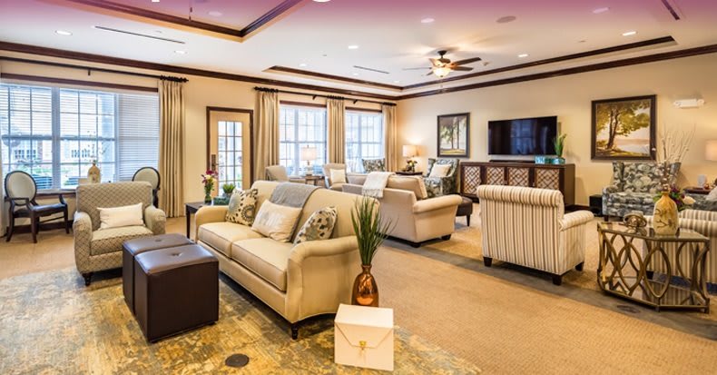 A spacious and elegantly designed living room with comfortable seating and stylish decor.
