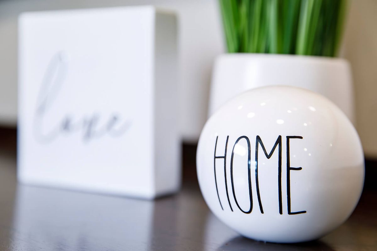 Minimalist home decor with a ceramic piece and greenery.