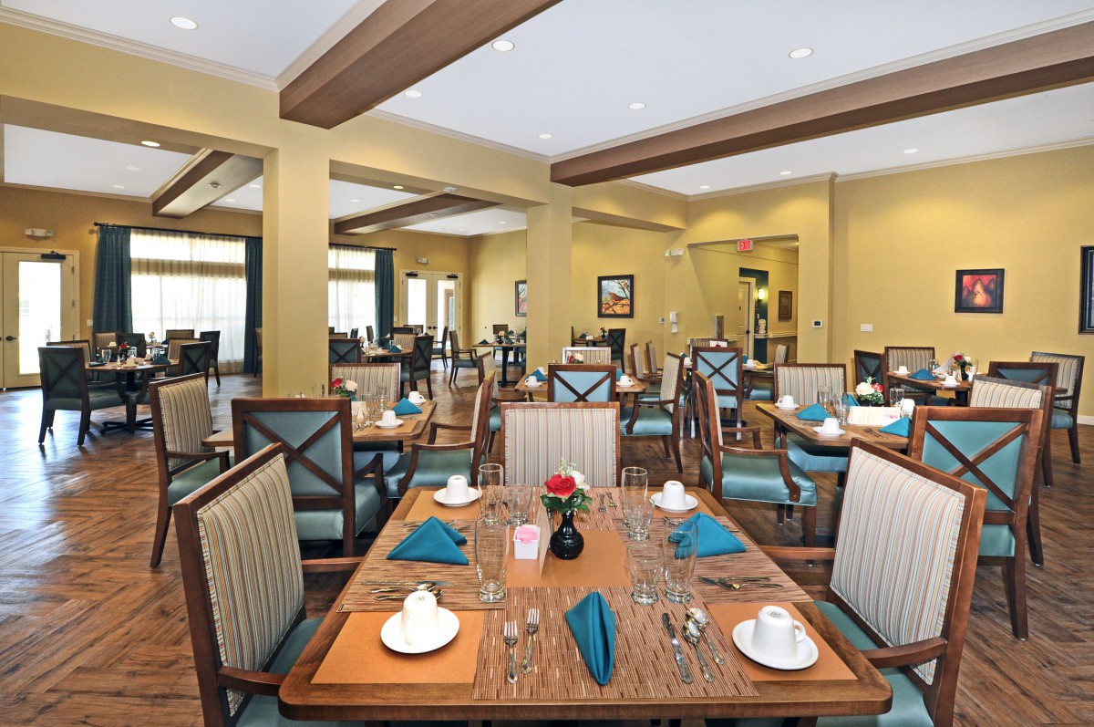 A well-decorated dining room with neatly arranged tables and chairs.