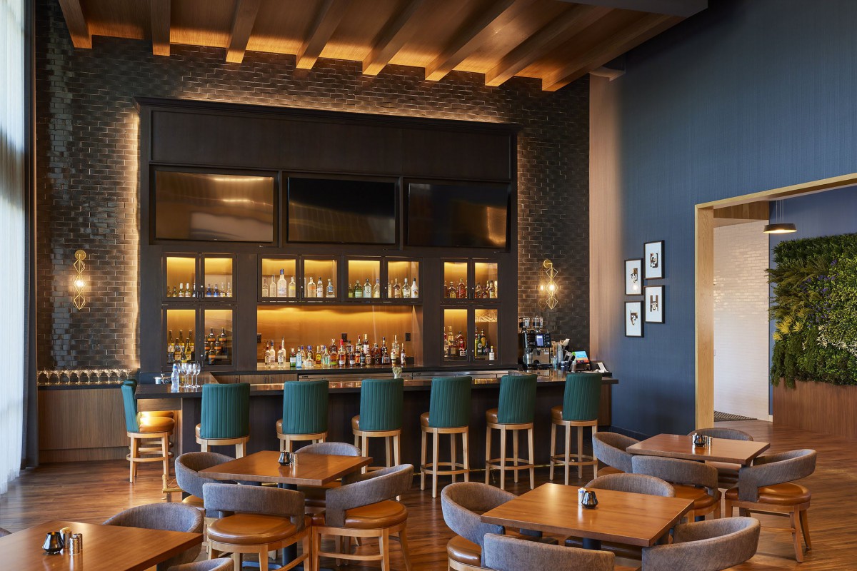 A stylish and modern bar interior with comfortable seating and warm lighting.