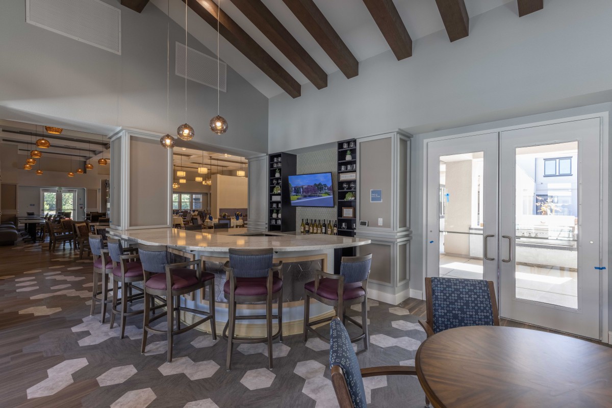 A modern bar and seating area with contemporary furniture and stylish lighting.