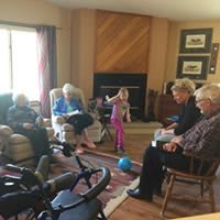 A family gathering in a cozy living room, with people of different generations spending time together.