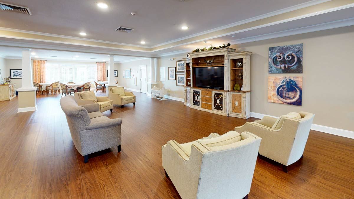 A spacious living room with comfortable seating and a large television.