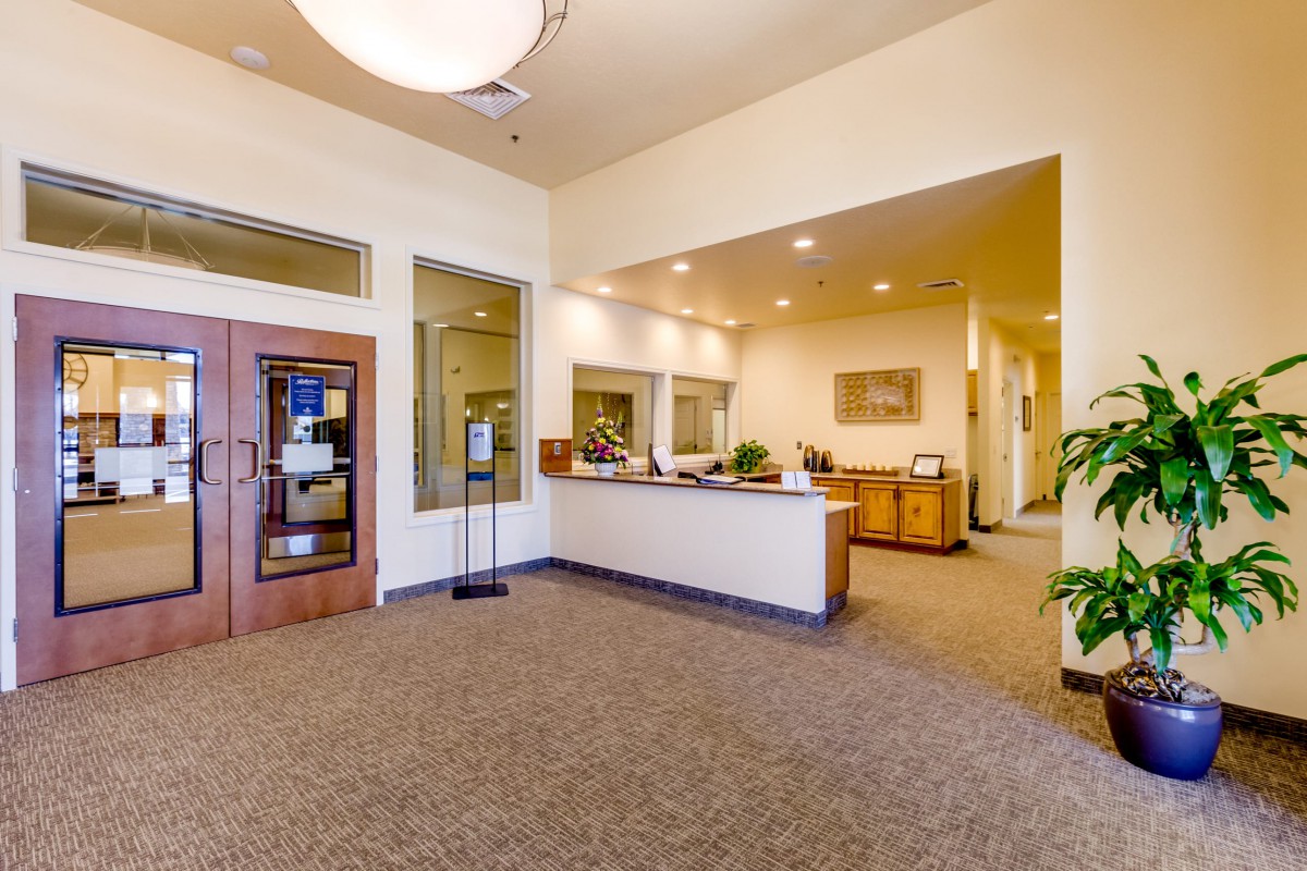 A spacious and well-lit office reception area with modern furnishings.