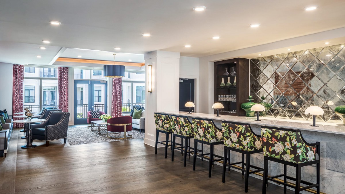 A modern bar area with chic seating and elegant lighting within a stylish interior space.