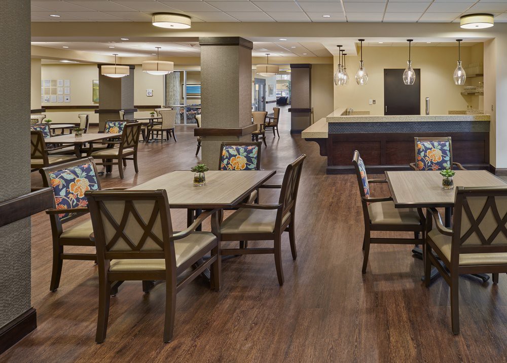 A spacious and elegantly designed dining area with neatly arranged tables and chairs.