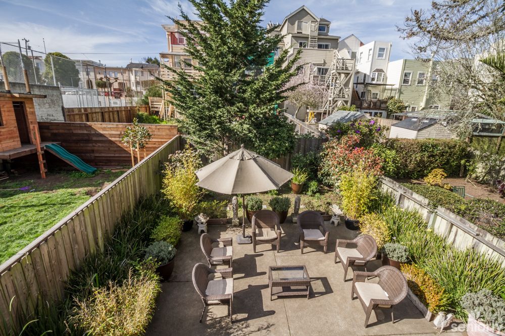 A well-maintained backyard with patio furniture and landscaping.
