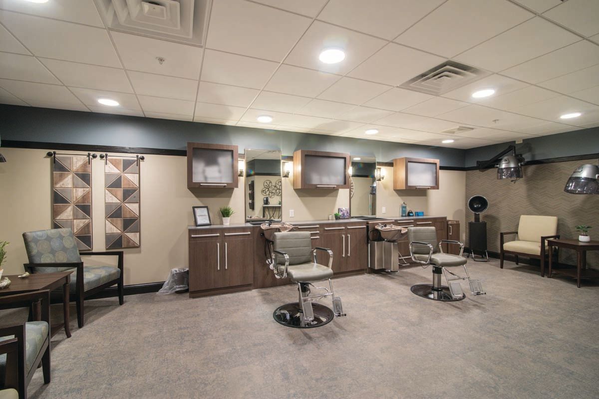 A modern hair salon interior featuring barber chairs and mirrors.