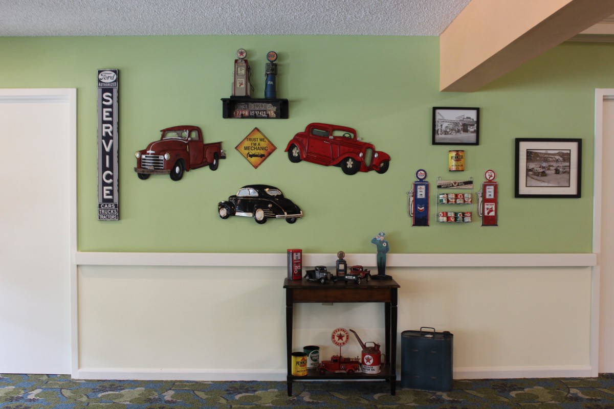 A room decorated with vintage automobile-themed wall art and retro signs.