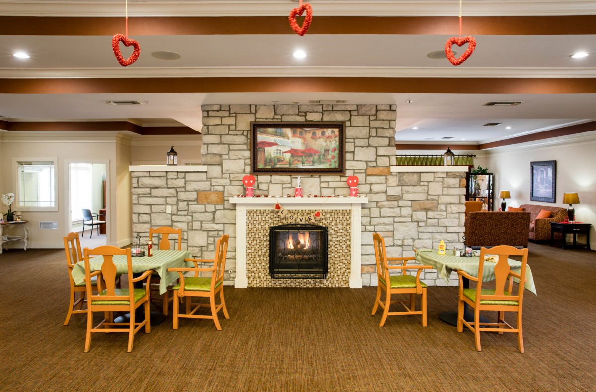 Cozy dining area with a fireplace and Valentine's Day decorations.