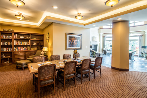 A well-appointed conference room featuring a spacious wooden table and comfortable seating, ideal for meetings and discussions.