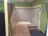 A staircase leading to a hallway with green painted walls and tiled flooring.