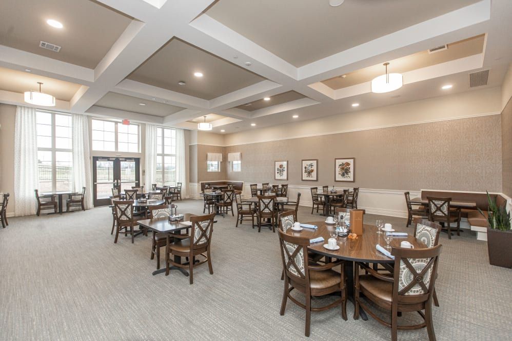 An elegantly designed dining area with neatly arranged tables and chairs.