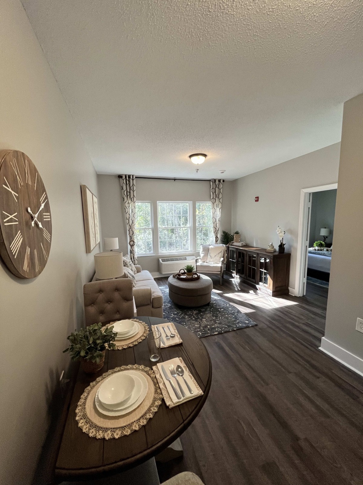 A modern living room and dining area with natural lighting and stylish decor.