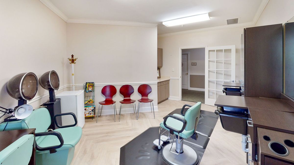 A bright, modern salon or office waiting area with colorful chairs and clean design.